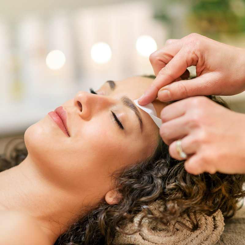 woman getting her eyebrows waxed