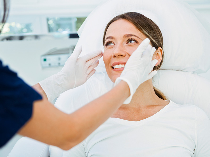 Doctor measuring a women's face.