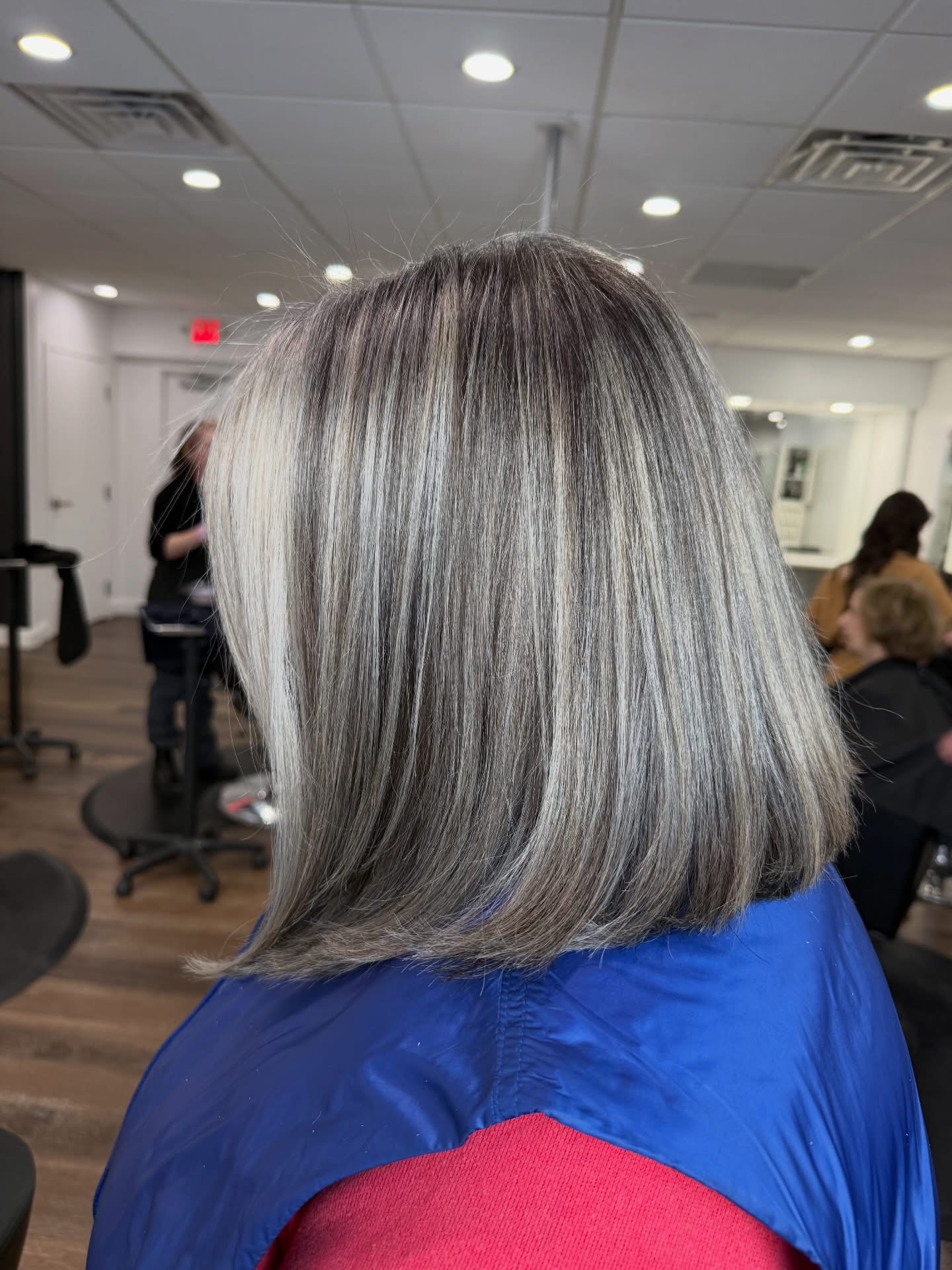 Soft layered silver gray hair, side view.