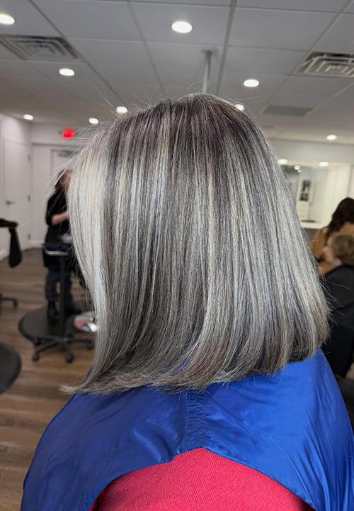 Soft layered silver gray hair, side view.
