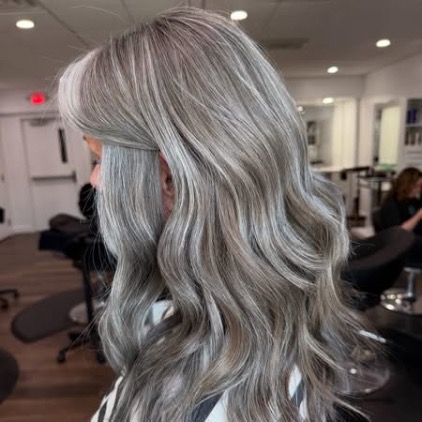 Soft layered silver gray hair, side view.