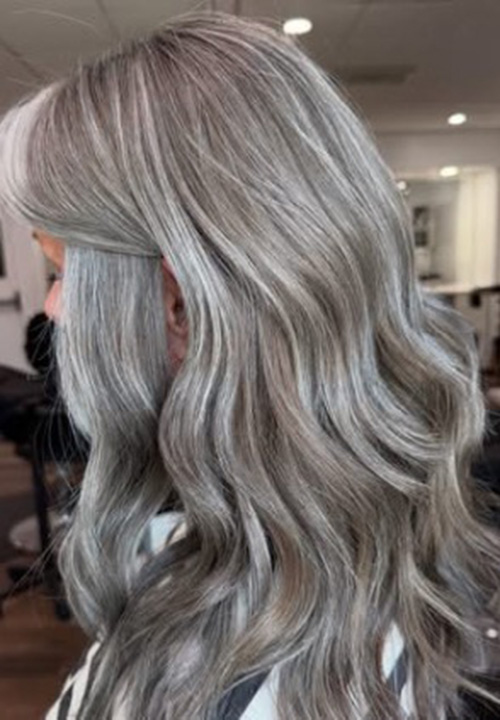 Soft layered silver gray hair, side view.