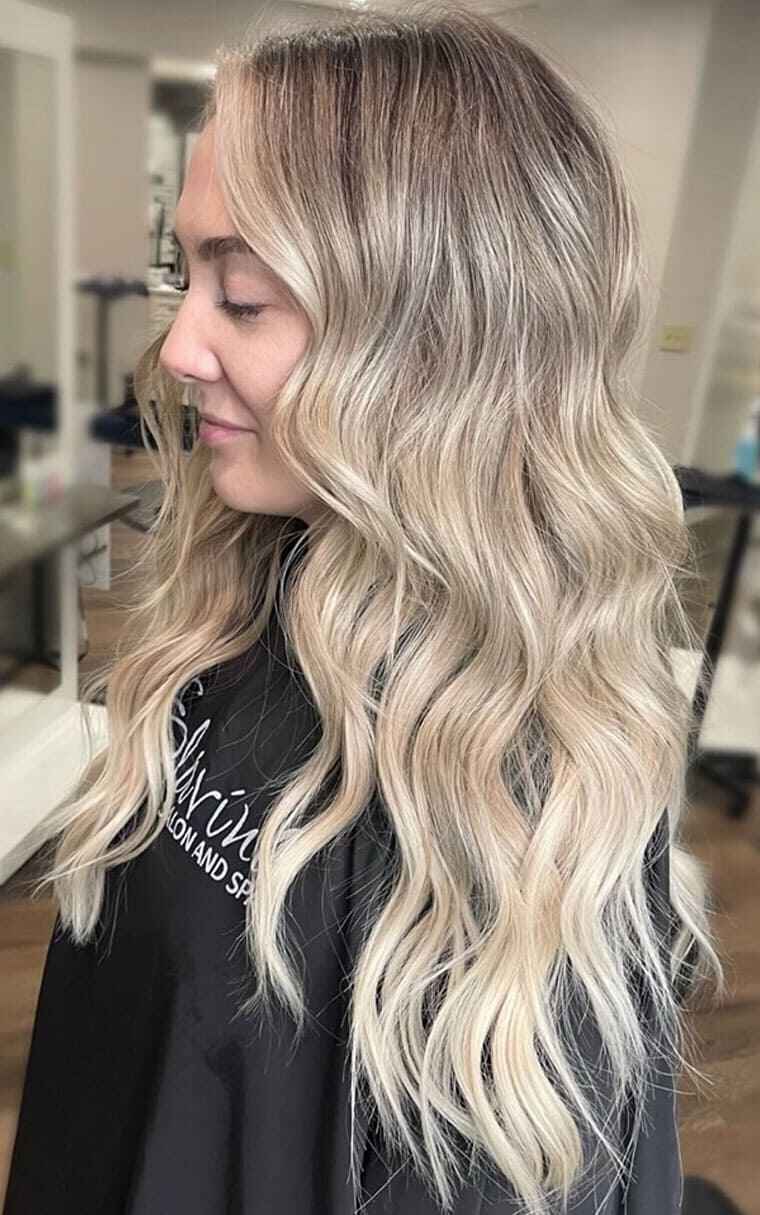 Back view of wavy hair highlights style change at Elavína Salon and Spa.